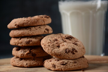 Chocolate chip cookies  with milk on wooden board 