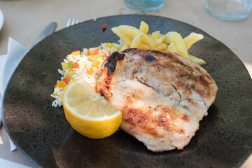 Chicken breast with rice salad and french fries