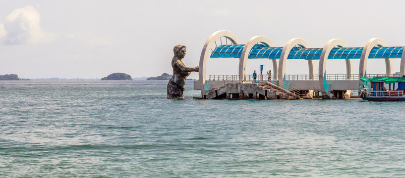 Rayong, Thailand - 21 October 2015: Pier to Koh Samet and statue of god Ko Samet is a famous tourist destination of Rayong, Thailand.