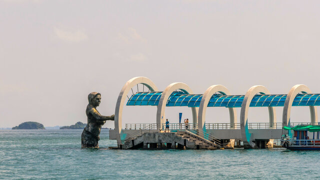 Rayong, Thailand - 21 October 2015: Pier to Koh Samet and statue of god Ko Samet is a famous tourist destination of Rayong, Thailand.
