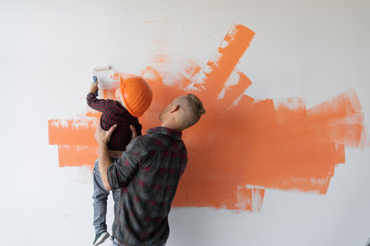 repairs his house, the father keeps his son and he helps him paint the wall with a roller,