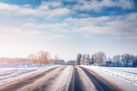 Winter Road With Snow And Trees All Around