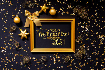 Fototapeta na wymiar Frame With German Text Frohe Weihnachten Und Ein Glueckliches 2021 Means Merry Christmas And A Happy 2021. Golden Christmas Decoration And Ornament Like Ball And Bow. Black Background With Glitter