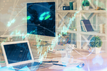 Financial chart drawing and table with computer on background. Double exposure. Concept of international markets.