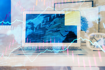 Forex market chart hologram and personal computer background. Multi exposure. Concept of investment.