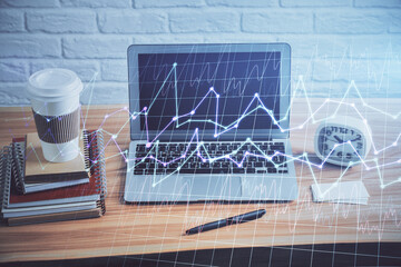 Double exposure of forex graph and work space with computer. Concept of international online...