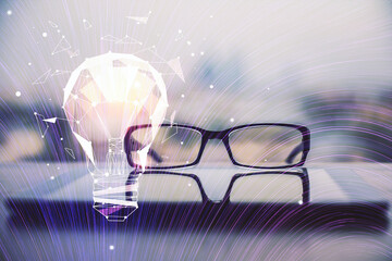 Bulb drawing with glasses on the table background. Idea concept. Double exposure.
