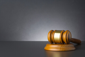 Wooden judge gavel against grey background , close up