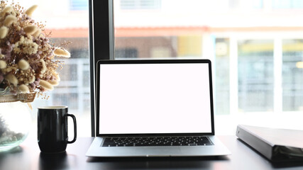 Fototapeta premium Mockup laptop on black wooden desk and graphic display mockup.