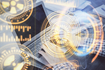 Technology theme hologram with man working on computer on background. High tech concept. Double exposure.