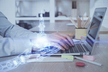 Start up drawings with businessman working on computer on background. Teamwork concept. Double exposure.