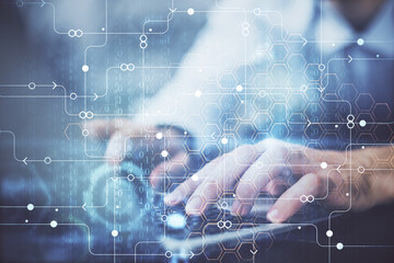 Multi exposure of data internet theme hologram with man working on computer on background. Concept...