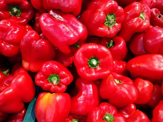 Sweet red pepper on the street market. Raw  peppers  on a store shelf.