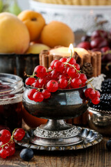Redcurrant (ribes rubrum) fruit in old silver bowl.