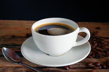 Hot coffee in a white cup on a wooden table