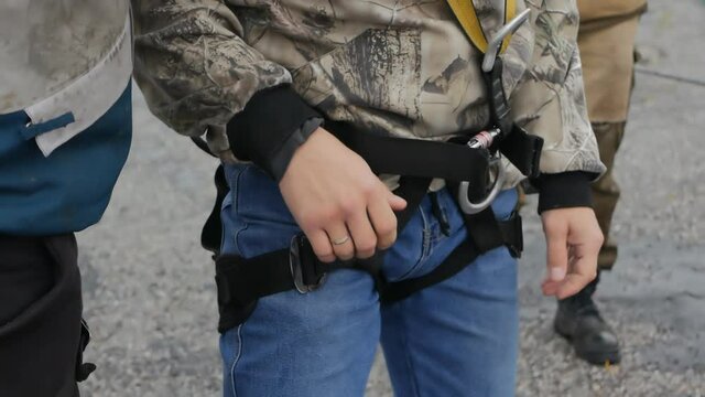 a military training instructor zips up training jumping equipment on a cadet. Special forces trainings. The equipment is put on and selected efficiently and reliably