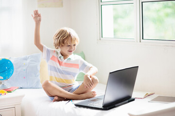 Online remote learning. School kids with computer.