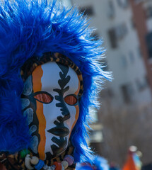Fototapeta na wymiar carnival mask with blue feathers, close-up