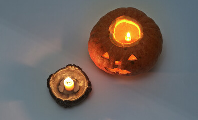 jack o lantern with a lighted candle, at the candleholder