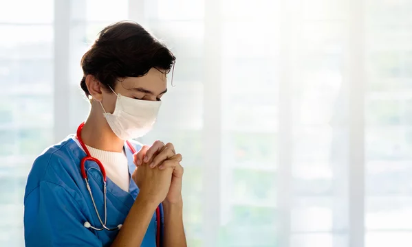 Asin Xxx Hd - Doctor in face mask praying for XXX Stock Photo | Adobe Stock