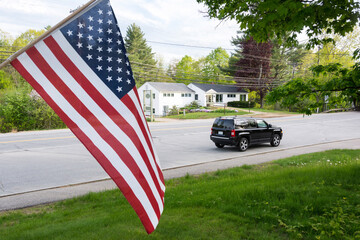 American flag and a black SUV