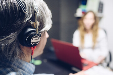 Senior man checks his hearing in hospital.Hearing care concept