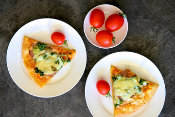 Pizza on a plate with tomatoes.