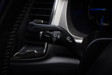 Fototapeta na wymiar Windscreen wiper control switch in car. Wipers control. Modern car interior detail. adjusting speed of screen wipers in car.