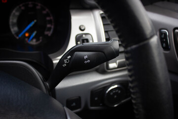 Switch off lights in a car. close-up Car integrated turning indicator with headlight switch toggle.