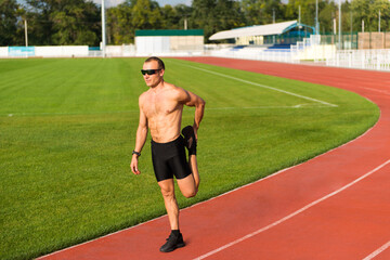 Runner stretches his legs on the track