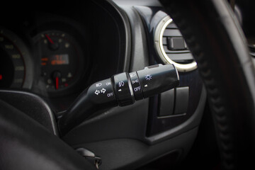 Switch off lights in a car. close-up Car integrated turning indicator with headlight switch toggle.
