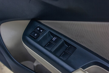 Car arm rest with Control Panel. Door Lock & Mirror Control. window adjustment buttons, door lock. Photography of a modern car.