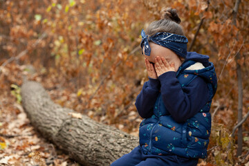 Little girl crying lost in the forest.