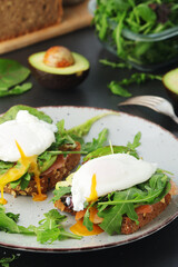Homemade sandwiches with salmon, avocado and poached eggs