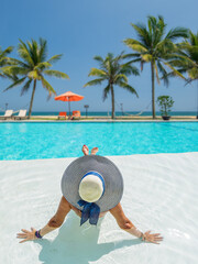 Fototapeta na wymiar woman in luxury spa resort near the swimming pool.
