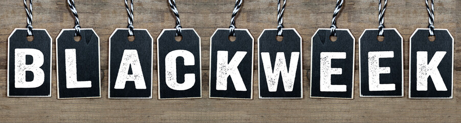 Black wooden hang tag with message Black Week on weathered wood background