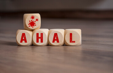 Cubes and dice with covid-19 corona virus and the german acronym for AHA - Abstand, Hygiene,...