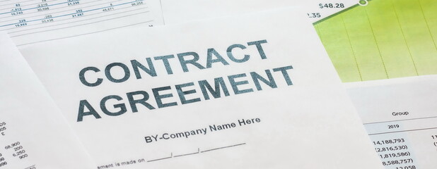 On the office table lies a contract paper for business cooperation.