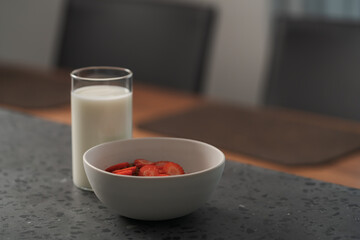 Organic oat granola with strawberry and yogurt on concrete background
