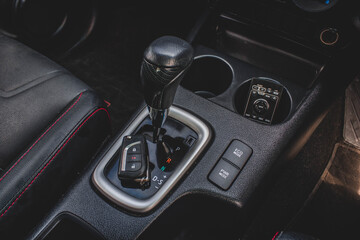 Fototapeta na wymiar automatic transmission shift selector in the car interior. Closeup a manual shift of modern car gear shifter.