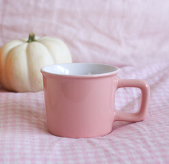 Cozy autumn morning breakfast in bed still life scene. A steaming cup of hot coffee, tea and white pumpkin. Fall. Thanksgiving concept.