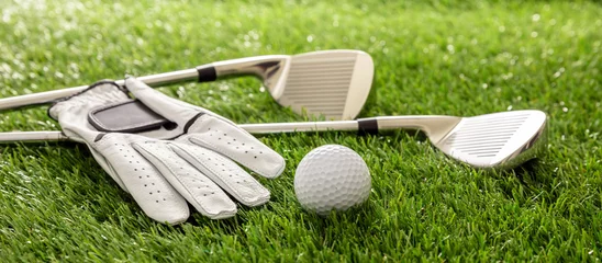 Gordijnen Golf equipment on green grass golf course, close up view. © Rawf8