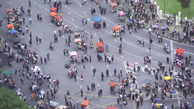 Aerial top view of flash mobs protesters demonstration rally on street road against government, crowd of people in Bangkok City, Thailand in public for democracy. Politics concept. Insurrection.