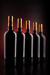 wine bottles with black background and red