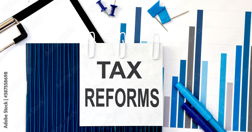 Poster notebook with toolls and notes about tax reforms on sticker ,concept