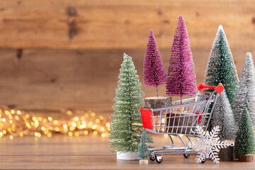 Colorful Christmas tree on wooden, bokeh background.