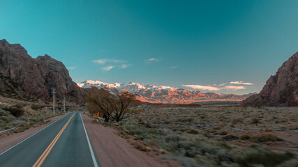 The roads near the border between argentina and chile with mountains in the background