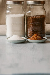 White and brown sugar in a bowl on rustic background. Different types of sugar.	