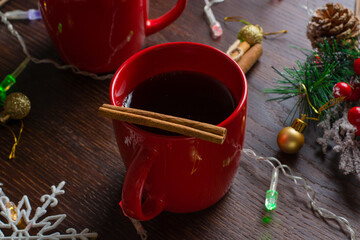 Mulled wine with cinnamon in a red cup. Christmas anticipation concept, view from above