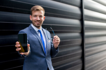 Professional man showing his cellphone
